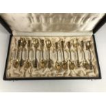 A cased set of twelve Norwegian silver-gilt coffee spoons, of a Moderne design with black