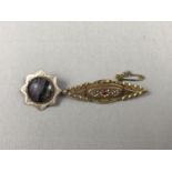 A Victorian Blue John cabochon brooch, claw and millegrain set within a star-shaped yellow-metal