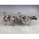 A pair of George V silver sauce boats, of Georgian shape, with flying scroll handles, Chester, 1928,