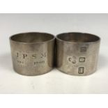 A pair of heavy silver napkin rings, each engraved with the dates 1941-1966, and respectively with