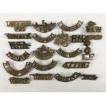 A quantity of British and Indian Army brass shoulder titles