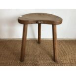 A Robert "Mouseman" Thompson (1876-1955) carved oak cow stool, having kidney shaped adzed top and