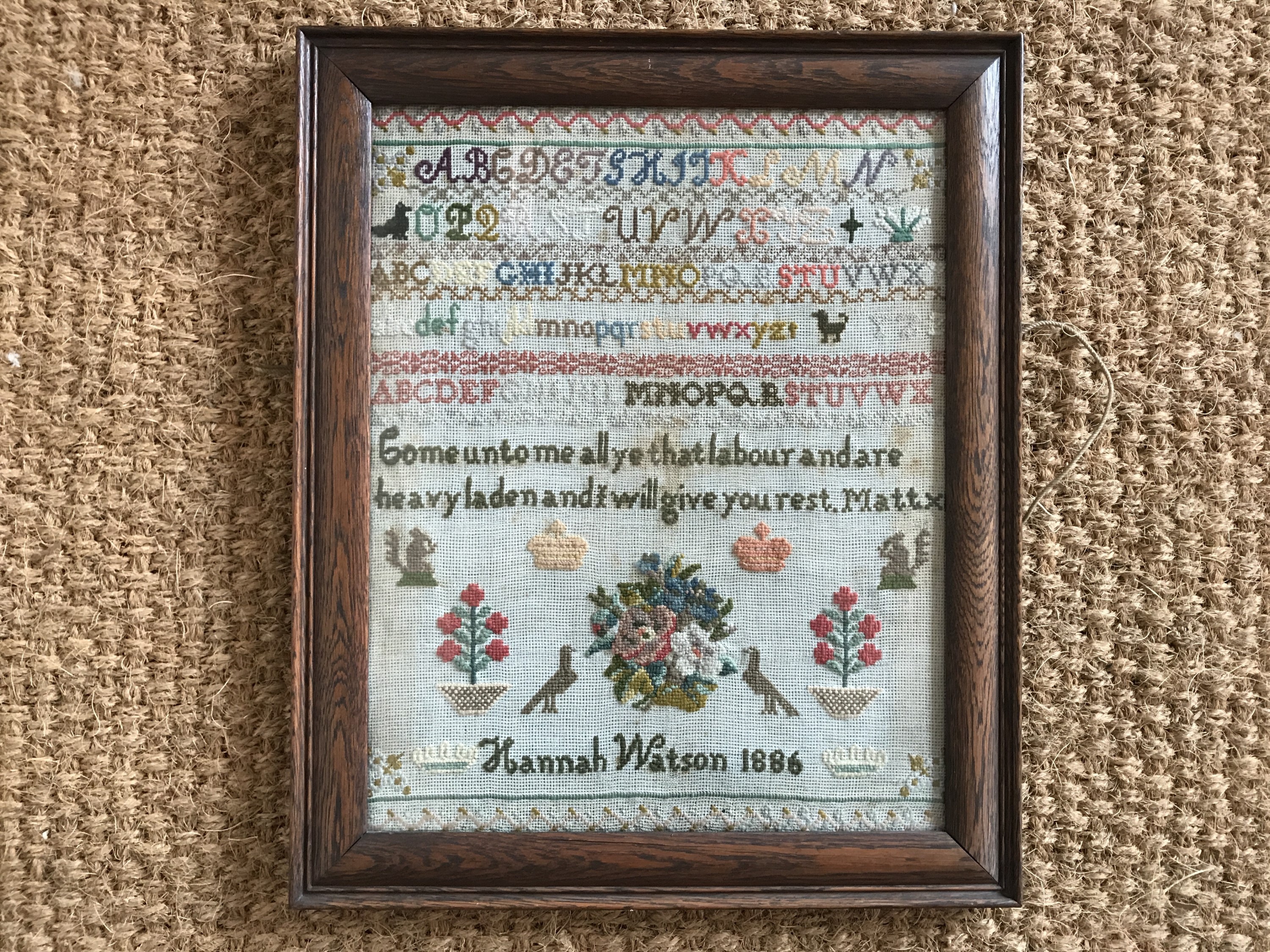 A Victorian needlework sampler worked by Hannah Watson in 1886, wool threads over aida,