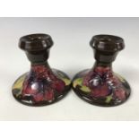 A pair of Moorcroft hibiscus pattern candlesticks, impressed marks, 9 cm high