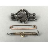 A Victorian novelty white-metal bar brooch modelled in the form of a horse jump surmounted by a