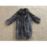 A mid-20th Century lady's muskrat fur coat, having stepped collar and bracelet length sleeves, lined