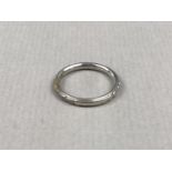 A vintage high-carat white metal wedding band, with foliate engraved decoration, stamped 19K,