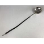 A George IV silver punch ladle with twisted baleen handle, having spirally fluted and foliate