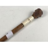 A late 19th Century walking cane, having a coquilla pommel carved as a satyr's head, with glass eyes