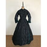 A Victorian emerald green and black brocade tablier dress, comprising one-piece dress and waist-belt