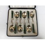 An early 20th Century cased set of white-metal and spinach-jade teaspoons retailed by Stewart Dawson