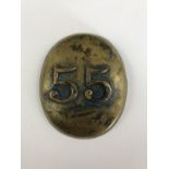 A saddlery or accoutrements brass badge, of dished oval form, bearing applied numerals 55, with