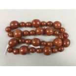 A single strand amber necklace, having large globular beads of approximately 25 x 22 mm,