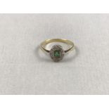 An early 20th Century emerald and diamond ring, having a square cut emerald of approximately .