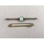 An early 20th Century opal and yellow-metal bar brooch, the cabochon being millegrain set and