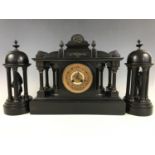 A 19th Century black slate mantle clock garniture, of architectural form, clock 35 cm high