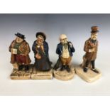 A group of four 1920s Bretby earthenware figurines modelled as figures from novels of Charles