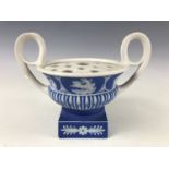 A Wedgwood blue Jasperware two-handled urn, of compressed campana form with removable rose, and