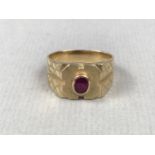 A gentleman's ruby and high-carat yellow metal dress ring, the face having a rub set and oval-cut