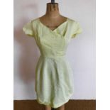 An early 1960s lemon-yellow ribbed tea dress, handmade, having cross-over neckline, a panelled and
