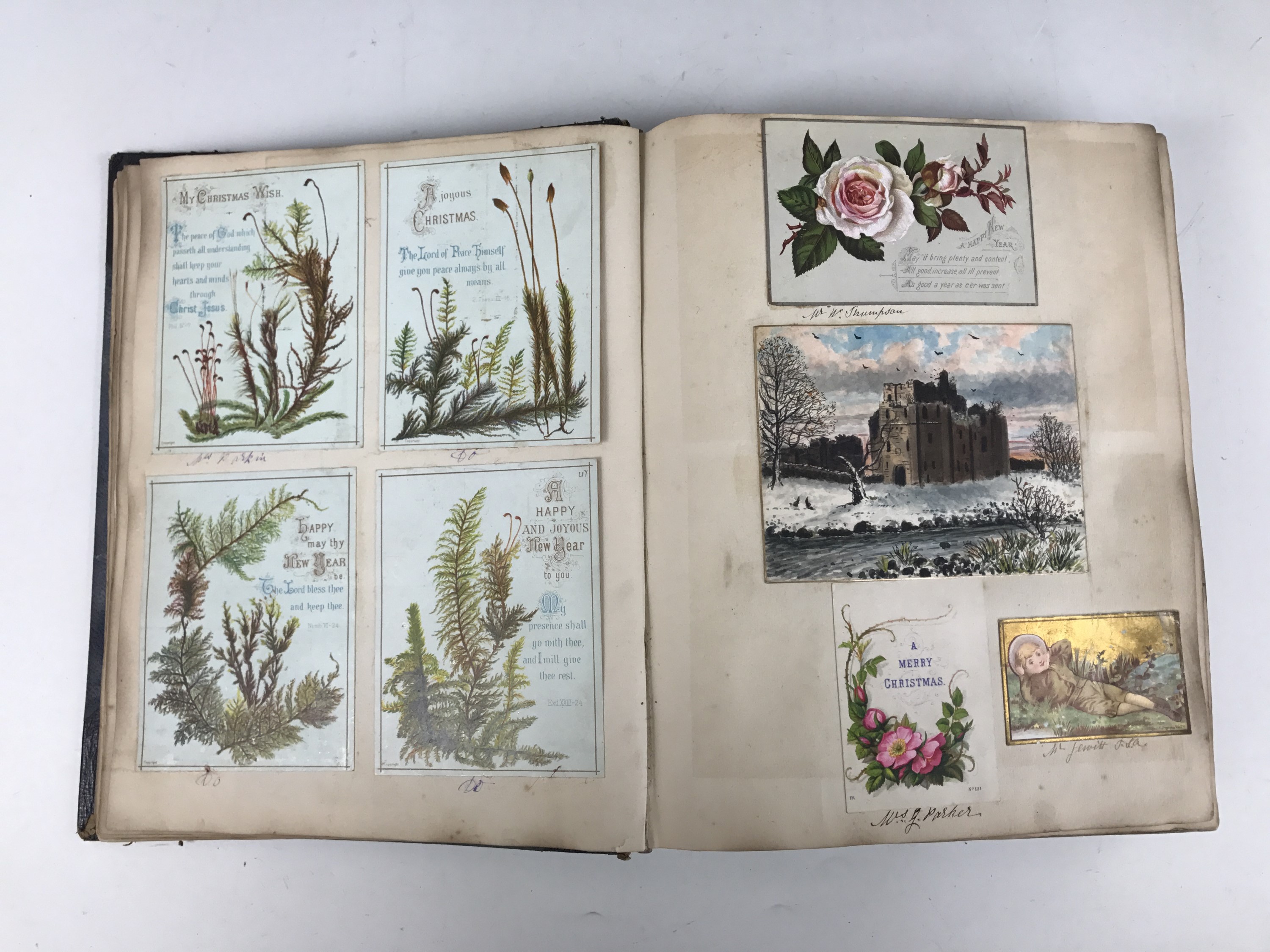 A late Victorian scrap album containing a collection of tipped-in Christmas cards, each with pen and