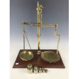 A set of early 20th Century Librasco brass counter-top beam scales, together with a set of metric "