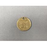 A Victorian 1887 gold half sovereign, holed