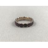 A Georgian almandine garnet and yellow metal eternity ring