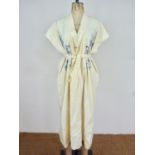 A 20th Century Chinese influenced Zoroastrian Parsi house coat of cream cotton having blue chain