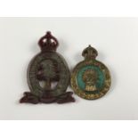 A Women's Land Army Timber Corps plastic cab badge together with a Women's Land Army enamelled