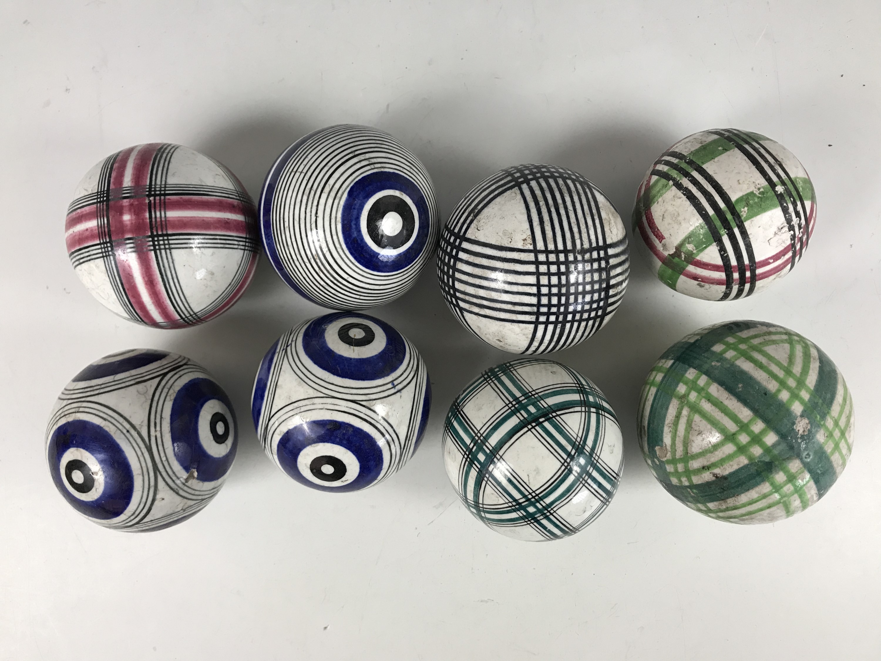 Eight 19th Century Scottish earthenware carpet bowls, hand painted with assorted geometric