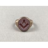 A late Victorian Masonic 9ct gold signet ring, having an engraved agate oval matrix