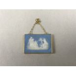 A yellow-metal mounted Wedgwood Jasperware pendant, depicting a classical scene, tests as gold