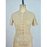 Three 1930s crocheted / knitted short sleeved blouses, one ecru example crocheted in a floral