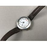 An early 20th Century lady's silver cased wrist watch, having a white enamelled dial with Arabic