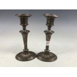 A pair of Adam style old Sheffield plate candlesticks