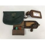 Vintage leather luggage tags, a leather "Slippers" pouch and a cased set of travelling dolly pegs