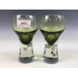 A pair of 1960s Caithness achromatising green glass goblets bearing 'C G' and Design Centre London