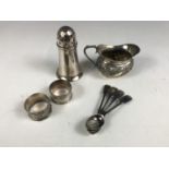 Two silver napkin rings, together with an electroplate cream jug, a sugar caster and four teaspoons