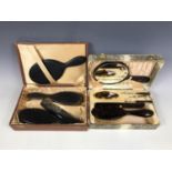 A cased grooming set comprising hairbrush and manicure items, together with one further cased