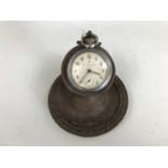 An early 20th century pocket watch stand with pocket watch