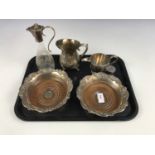 A pair of electroplate bottle coasters, together with a cream jug, and one further glass and