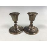 A pair of George V silver diminutive candlesticks, Birmingham, 1926, loaded