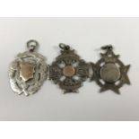 Two silver watch fobs together with one other