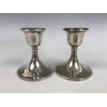 A pair of silver diminutive candlesticks, 10 cm