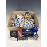 A large quantity of golf balls together with tees