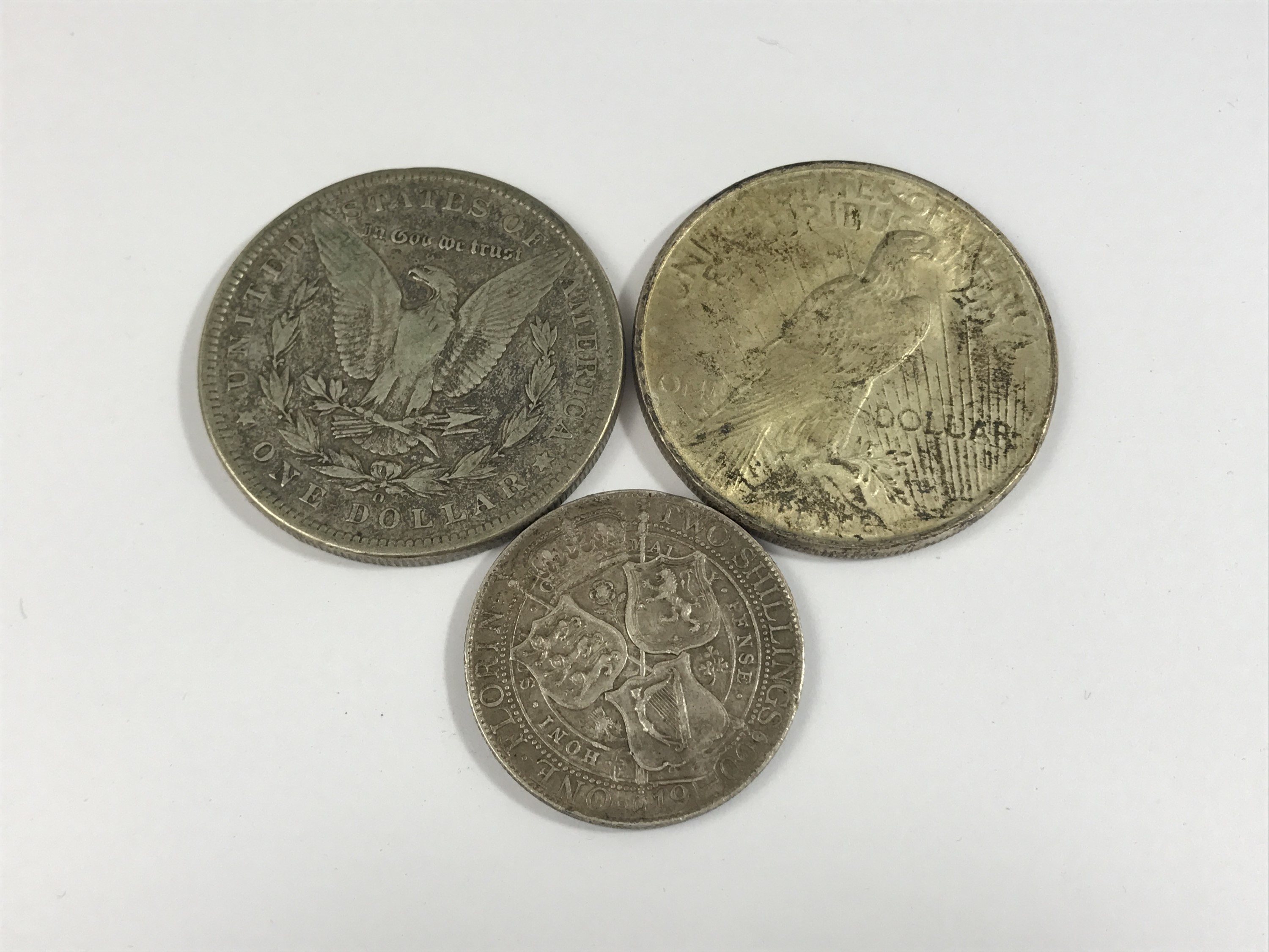 An 1899 and 1922 US silver dollar coins, together with a 1900 florin