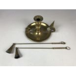 A brass chamber stick together with two candle snuffers