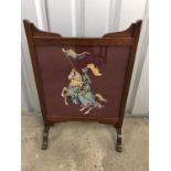 A mahogany framed tapestry fire screen embroidered with St George