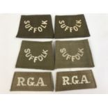 A quantity of First World War British Army slip-on cloth shoulder titles